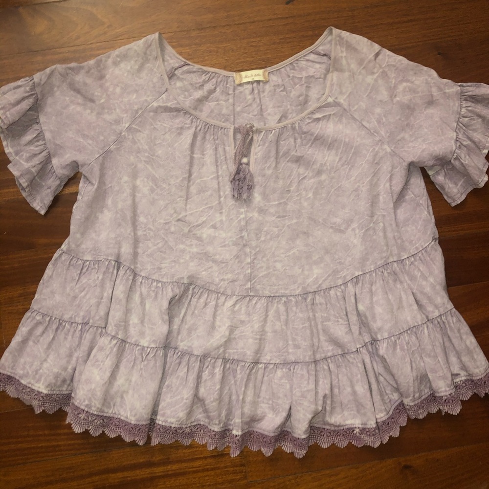 Light purple flowy shirt.